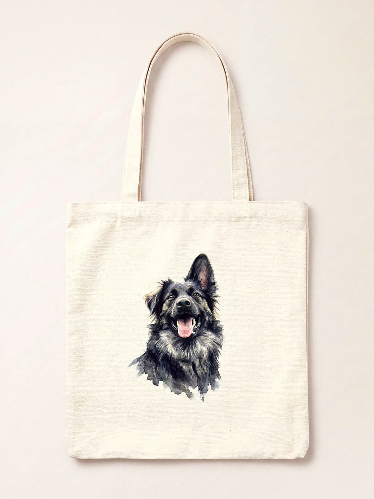A watercolour portrait of a black and tan shepherd dog printed on a natural cotton tote bag