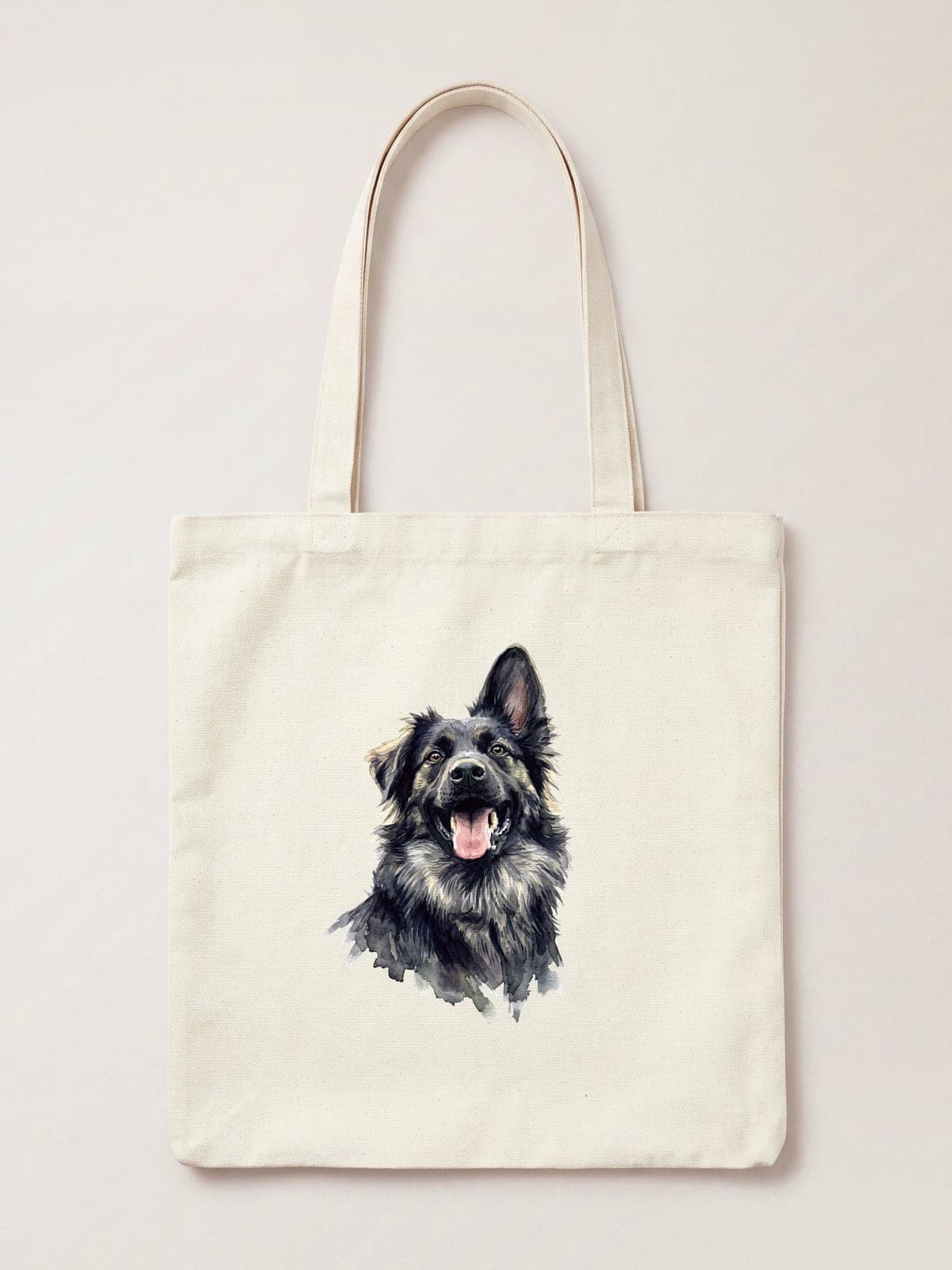 A watercolour portrait of a black and tan shepherd dog printed on a natural cotton tote bag