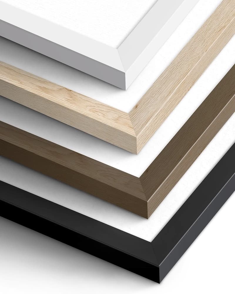 Four paper print frame corners stacked: white, natural light wood, dark brown wood and black